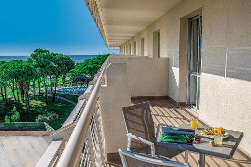a balcony with a table and chairs and the ocean at Hotel San Giorgio Resort 4S in Caorle