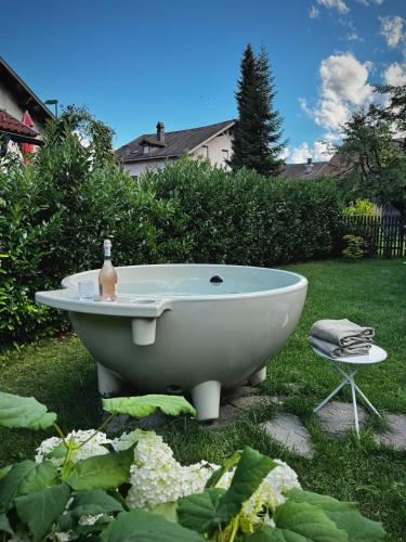 a bath tub sitting in the grass in a yard at Haus Gamper-Haselwanter in Tarrenz