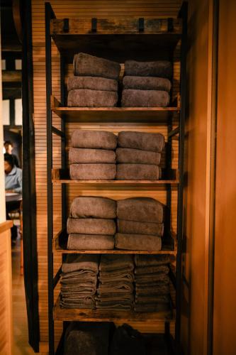 a stack of towels on a shelf in a room at 古民家宿 孫八 - Mago8 in Maibara