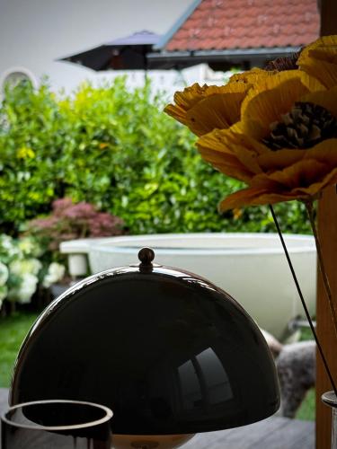 a vase with a yellow flower on a table at Haus Gamper-Haselwanter in Tarrenz
