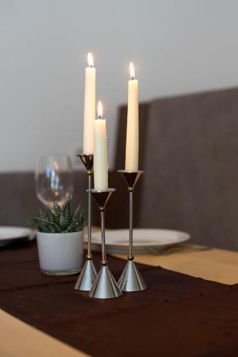a group of three candles on a table at Apart Praxmarer in Sölden