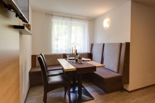 a dining room with a table and chairs and a window at Apart Praxmarer in Sölden