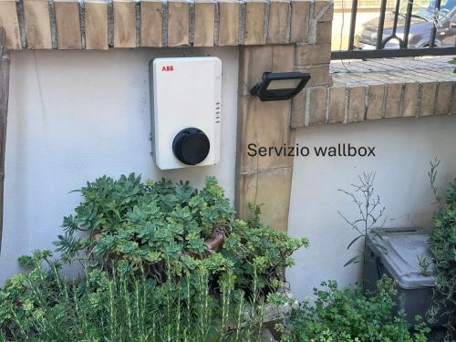 a utility box on the side of a wall with plants at Cloe b&b di Angela Libertini in Penne
