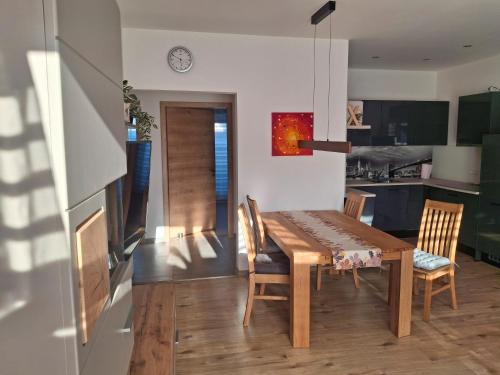 a kitchen and dining room with a wooden table and chairs at Fewo im Fränkischen Seenland in Untereschenbach