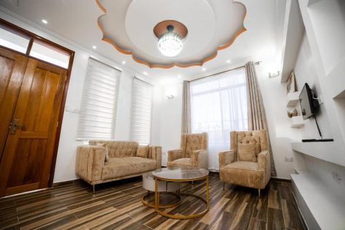 a living room with two chairs and a table at Hamidu City Park in Dar es Salaam