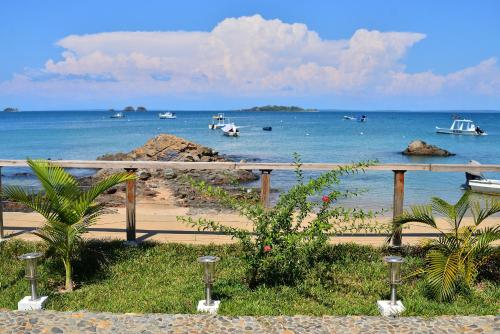 a view of a beach with boats in the water at Hôtel de rêve Nosy Komba in Nosy Komba