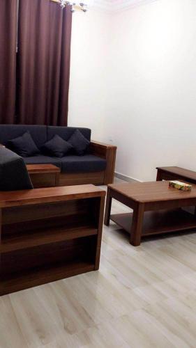 a living room with a couch and a coffee table at Al Noor Saadah Furnished Apartments in Salalah