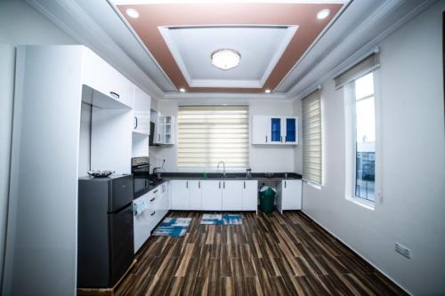 a kitchen with white walls and a ceiling at Hamidu City Park in Dar es Salaam