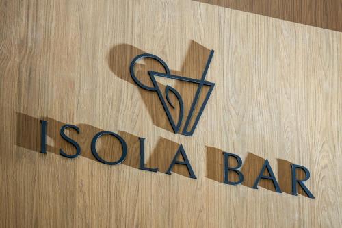 a sign for a sushi bar on a wooden wall at Novotel Malta Sliema in Il-Gżira