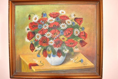 a painting of a vase of flowers on a table at Haus Treffer in Kirchdorf in Tirol