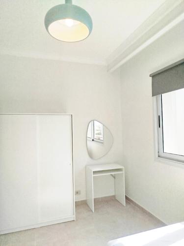 a white room with a mirror and a table at Bay breeze in Hurghada