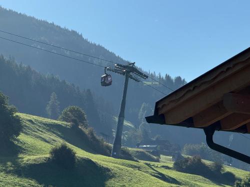 a ski lift on a hill with a grassy slope at Haus Viki in Sesto