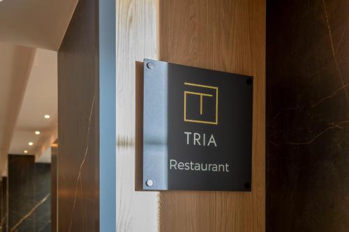 a sign on a door that reads trka restaurant at Novotel Malta Sliema in Il-Gżira