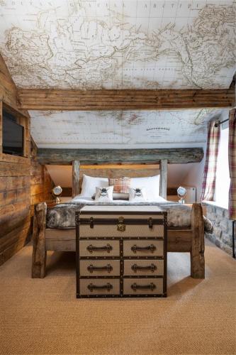 a bedroom with a bed with a map on the wall at The Craven Heifer in Addingham