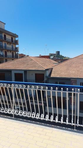 a white fence in front of a building at La Luna e la Rana Vacation Home in Paterno