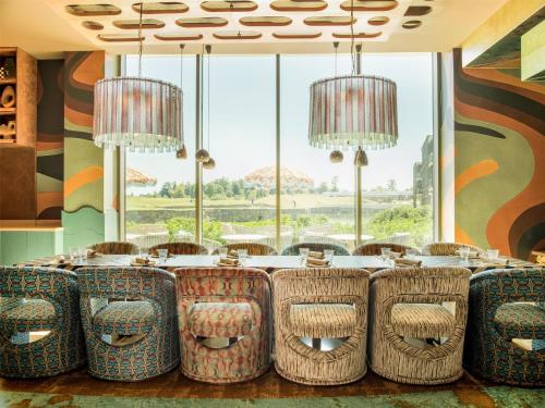a dining room with a long table and chairs at Radisson Collection The National Hotel, Brussels in Zaventem
