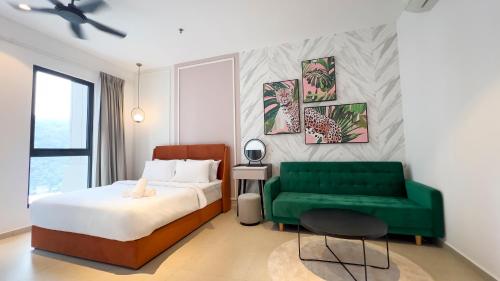 a bedroom with a bed and a green couch at Paxtonz Suite Damansara by Light House in Kuala Lumpur