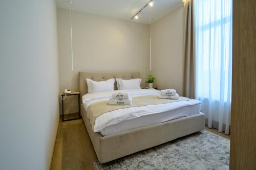 a bedroom with a large bed with white sheets at Forest Retreat Center in Kyiv