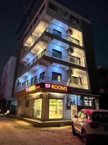 a building with a car parked in front of it at S R Hotel in Jāmb