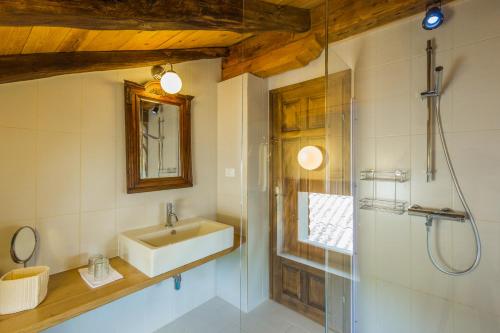 a bathroom with a sink and a shower at Ivanini secluded stone Villa with a stunning view in Brseč