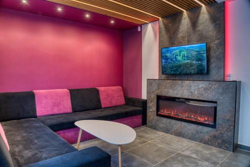 a room with a couch and a fireplace at MátraForRest in Mátraszentistván