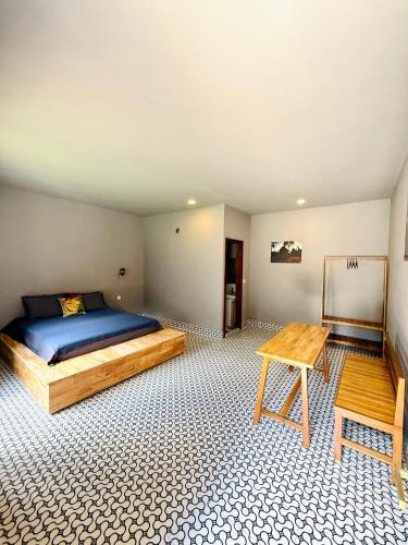 a bedroom with a bed and a table in it at Angkor Piseth Retreat in Phumi Ta Phul