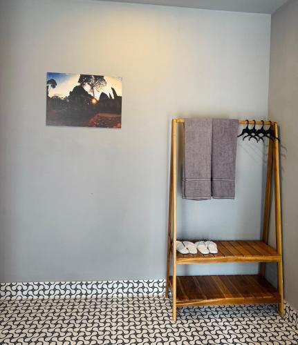 a room with a shelf with towels on a wall at Angkor Piseth Retreat in Phumi Ta Phul