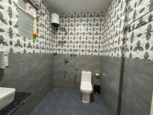 a bathroom with a toilet and a sink at Zuna Stayz Morjim in Morjim