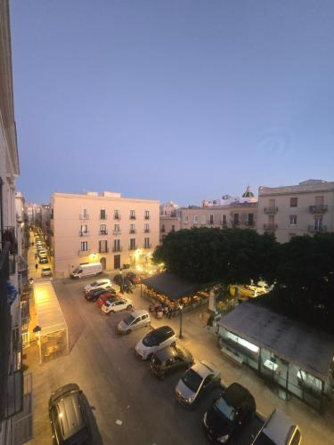 a parking lot with cars parked in front of buildings at CasaNostra11 centro città e mare wifi 2 camere in Trapani
