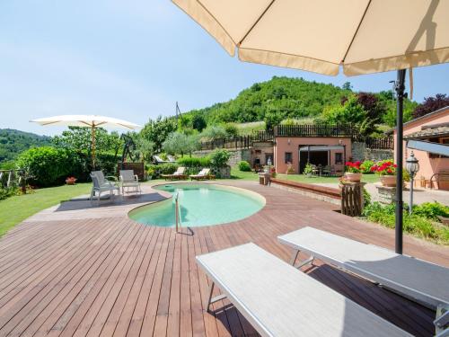 a patio with a swimming pool and an umbrella at Pet-Friendly Villa with Pool in Urbino
