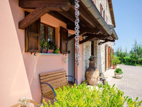 a building with a bench and a window at Pet-Friendly Villa with Pool in Urbino