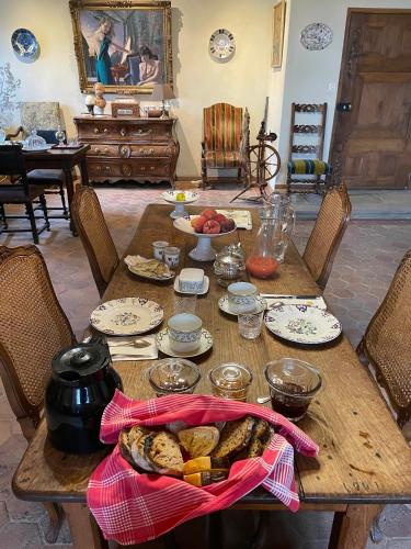 a wooden table with food on top of it at Château du Bouy in Champétières