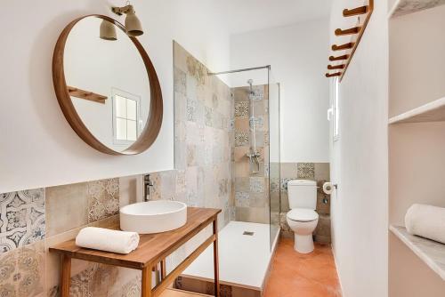 a bathroom with a toilet and a mirror at Son Pere - Romantic Hilltop Stay in Ferreries