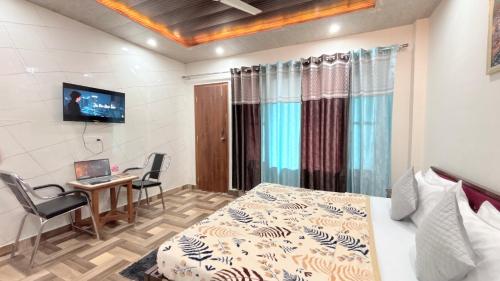 a bedroom with a bed and a desk with a laptop at TreeHouse Kasauli Operated By Splendid Hotels I Vacations I Family Groups & Events I Forest Treks I Memories I in Kasauli