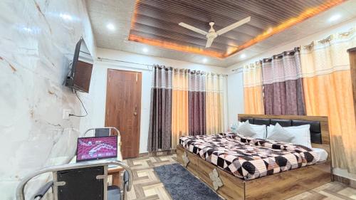 a bedroom with a bed and a tv in it at TreeHouse Kasauli Operated By Splendid Hotels I Vacations I Family Groups & Events I Forest Treks I Memories I in Kasauli