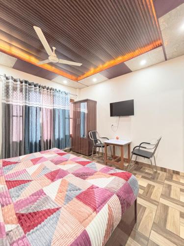 a bedroom with a bed and a table with chairs at TreeHouse Kasauli Operated By Splendid Hotels I Vacations I Family Groups & Events I Forest Treks I Memories I in Kasauli