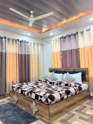 a bedroom with a bed in a room with curtains at TreeHouse Kasauli Operated By Splendid Hotels I Vacations I Family Groups & Events I Forest Treks I Memories I in Kasauli