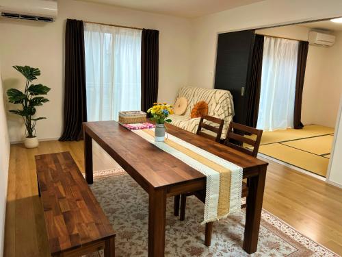 a living room with a table and a couch at 藍遊び in Fukuoka
