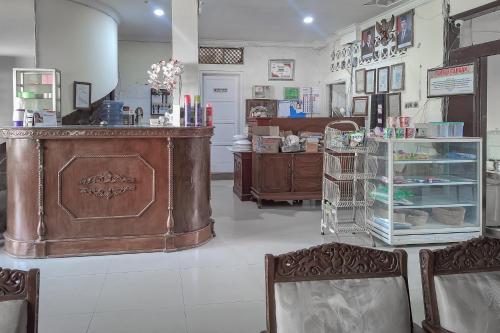 a store with a counter and chairs in a room at RedDoorz Syariah at Hotel Adi Sederhana near Stasiun Jatibarang in Sleman