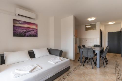 a living room with a bed and a table at Villa Royal 2 with a pool in Novalja