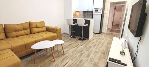 a living room with a couch and a table at MJ apartments in Vršac