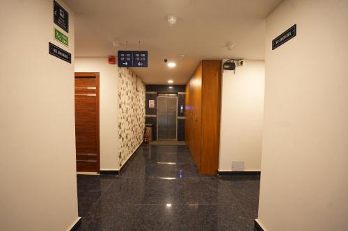 a hallway of a building with a door and a hallway at Elite Hotel HITECH in Hyderabad