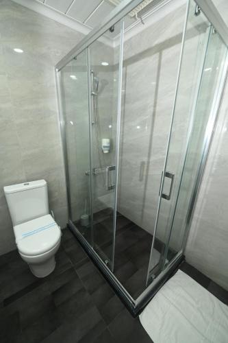 a bathroom with a shower and a toilet at DOME Hotel & Casino Central Kyrenia in Kérynia