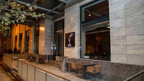 a restaurant with tables and chairs in a building at Holiday Inn Baku by IHG in Baku