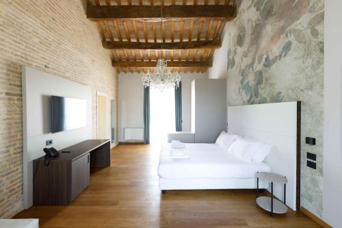 a bedroom with a white bed and a desk at Villa Roncuzzi 