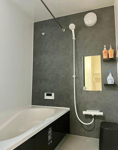 a bathroom with a bath tub and a shower at 藍遊び in Fukuoka