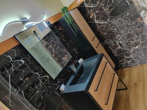 a kitchen with a counter and a tv on a marble counter top at Bel Horizon in Saint-Jean-Froidmentel