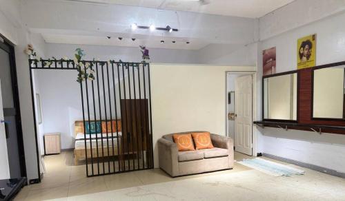 a living room with a chair and a mirror at Peaceful Family Retreat in Honiaras Heart in Panatina