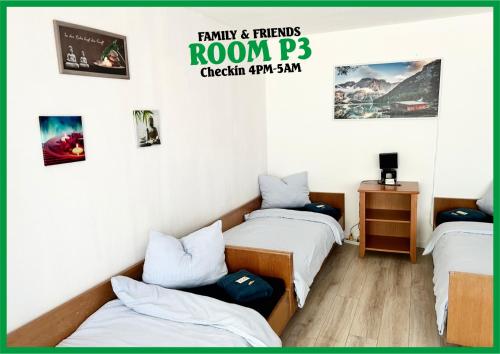 two beds in a room with pictures on the wall at Family & Friends Room P3, 5 beds, 25qm, Check-in 4PM till 5AM in Creglingen