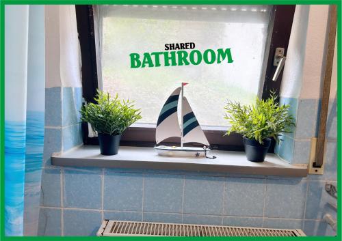 a window with a toy sailboat on a window sill at Family & Friends Room P3, 5 beds, 25qm, Check-in 4PM till 5AM in Creglingen